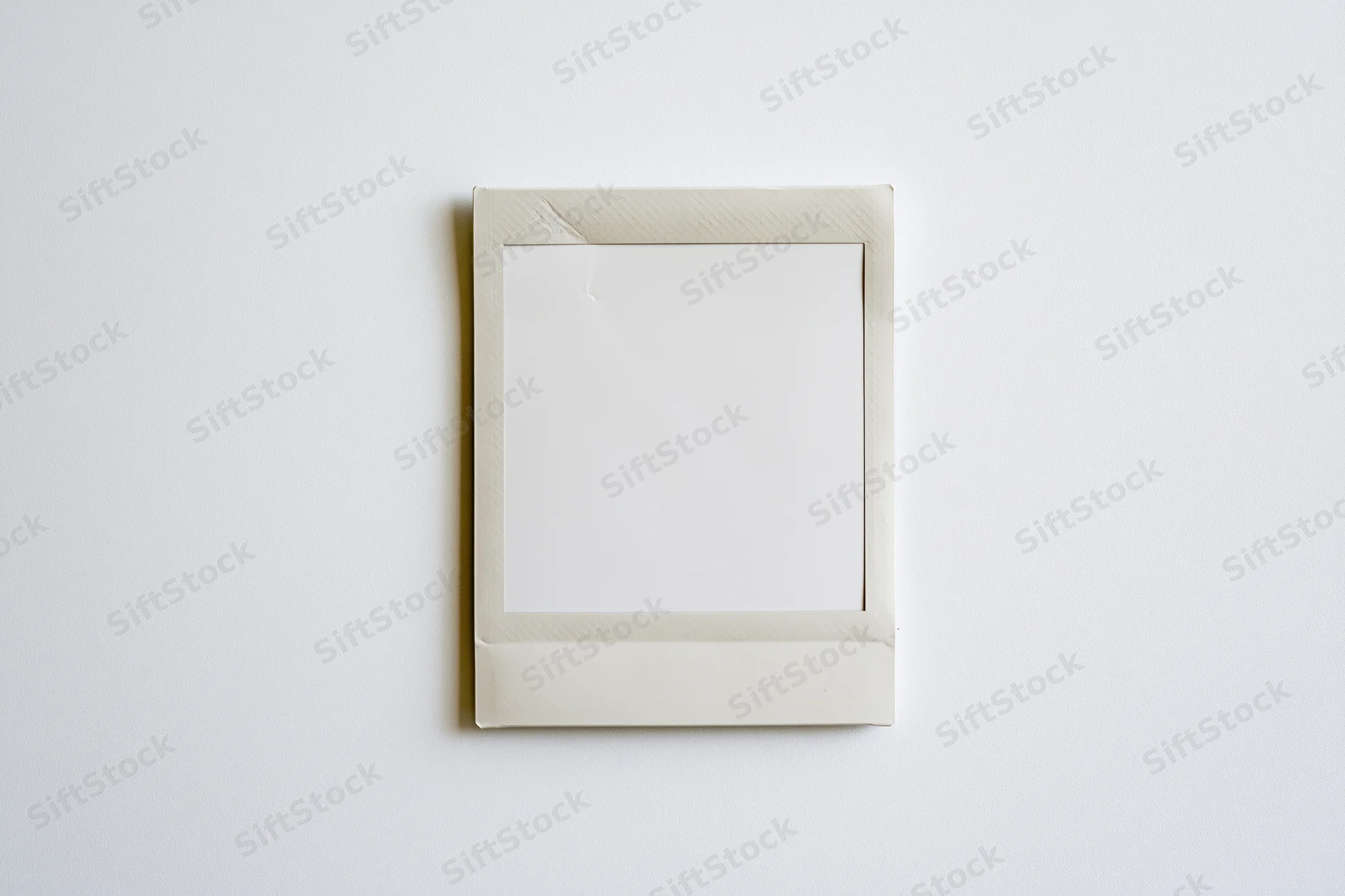 Blank instant film print lying flat on white surface