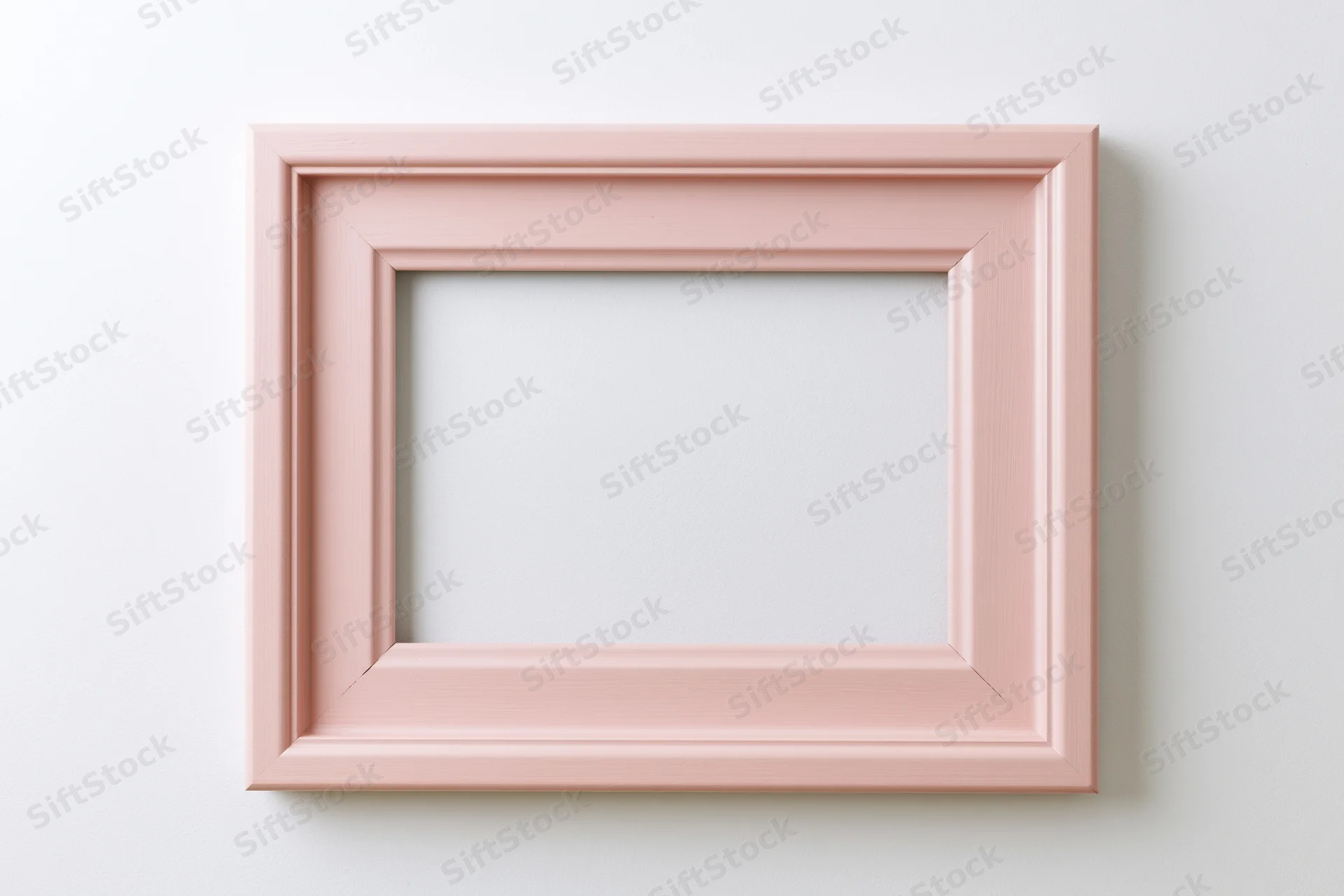 Pale pink wooden picture frame with simple molded edges hanging on white wall