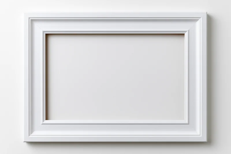 White wooden picture frame hanging on a plain wall with empty center for display