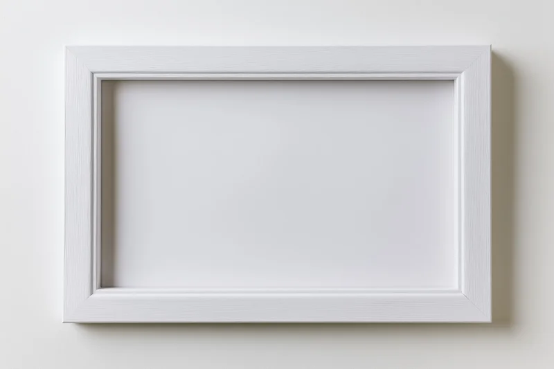 White rectangular picture frame hanging on a plain wall with empty interior space for display