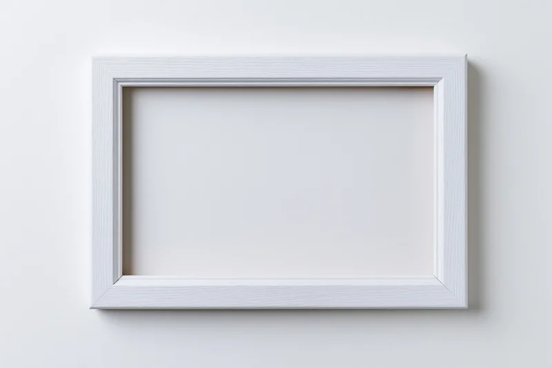 White rectangular picture frame mounted on a plain wall with empty interior space