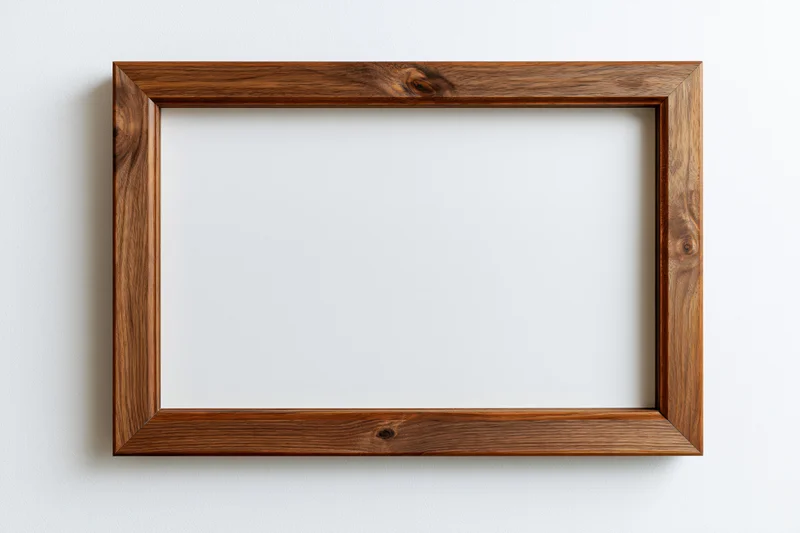 Wooden picture frame hanging on white wall with empty center