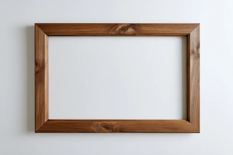 Wooden picture frame lying flat on white surface with empty center and visible wood grain