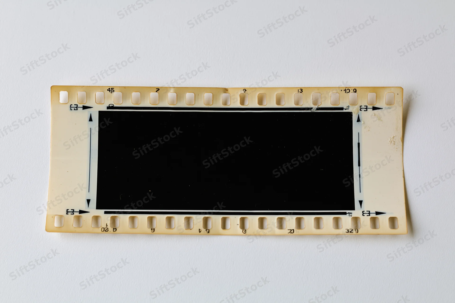 Blank 35mm film negative strip laid flat on white background