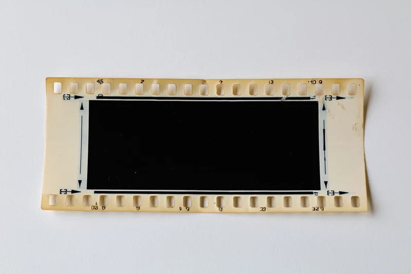 Blank 35mm film negative strip laid flat on white background
