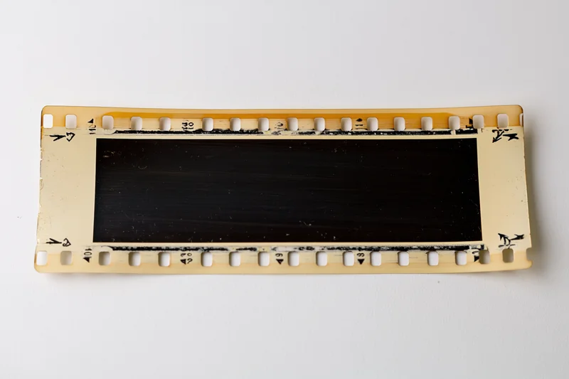 Blank 35mm film negative strip laid flat on white background