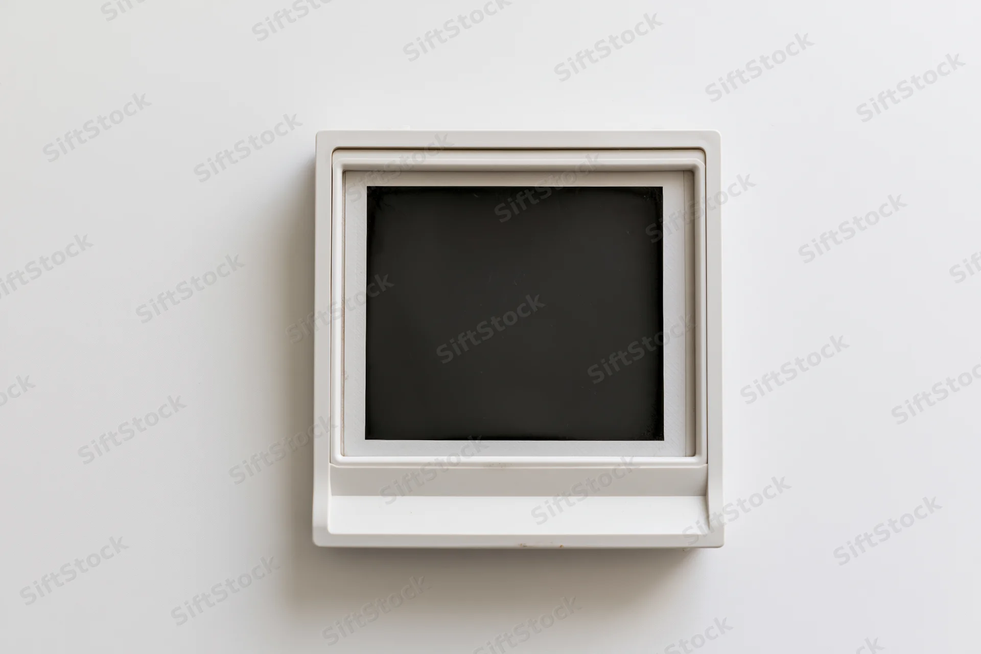 Blank polaroid instant photo print centered on white surface
