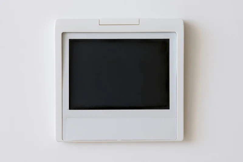 Blank polaroid instant photo print lying flat on white surface