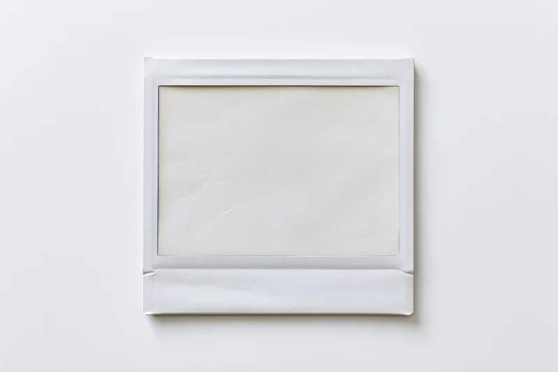 Blank instant photo print lying flat on white surface