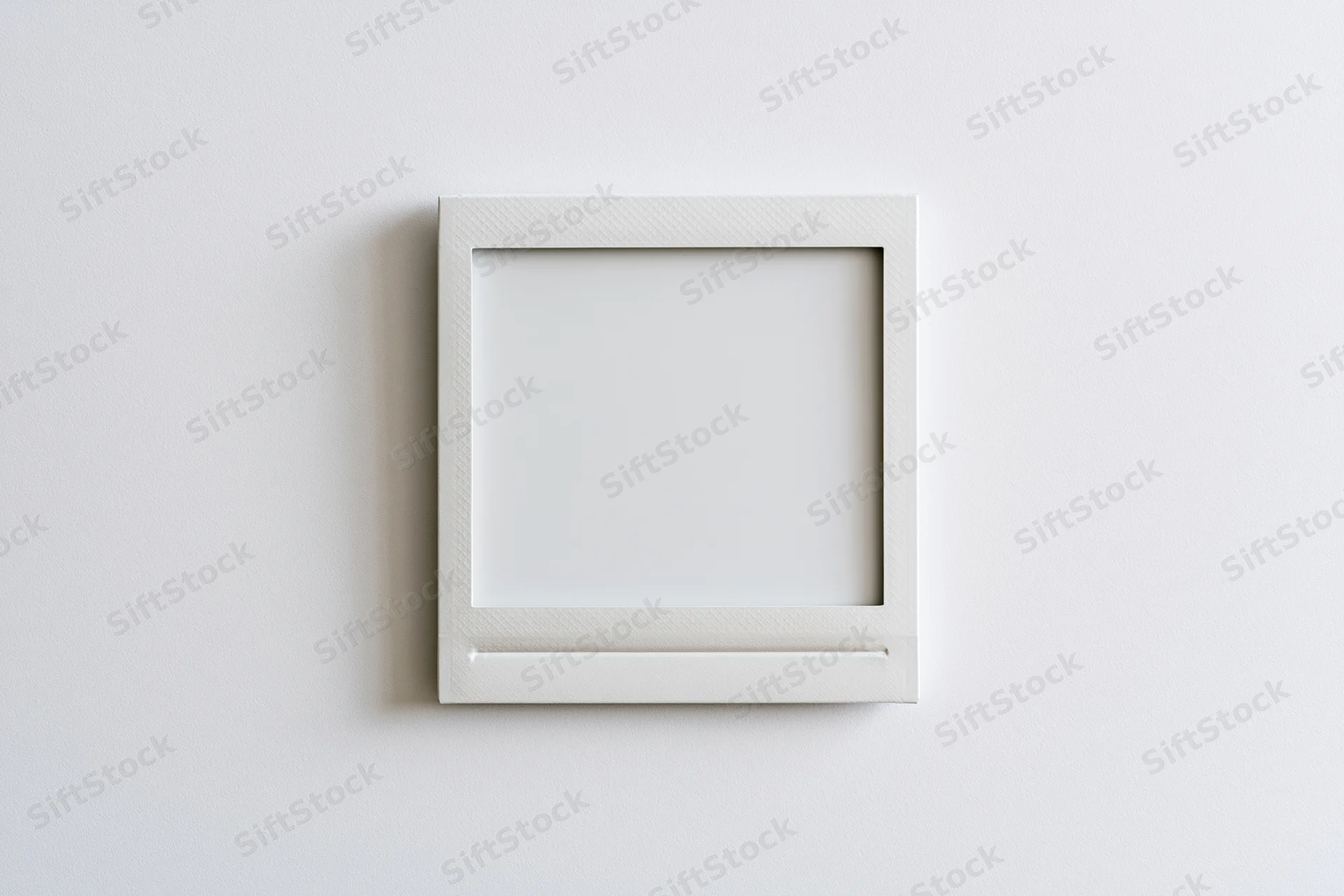 Blank instant photo print lying flat on a white surface
