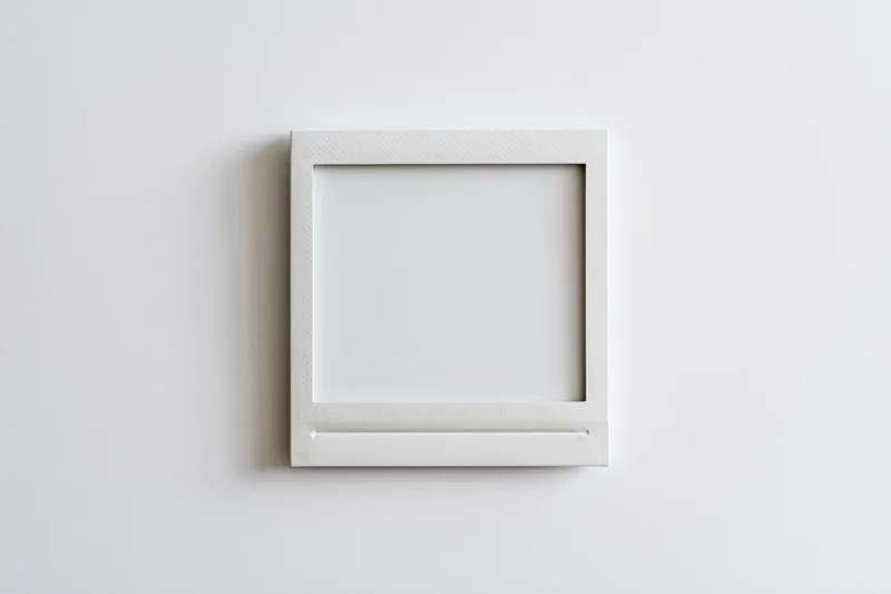Blank instant photo print lying flat on a white surface