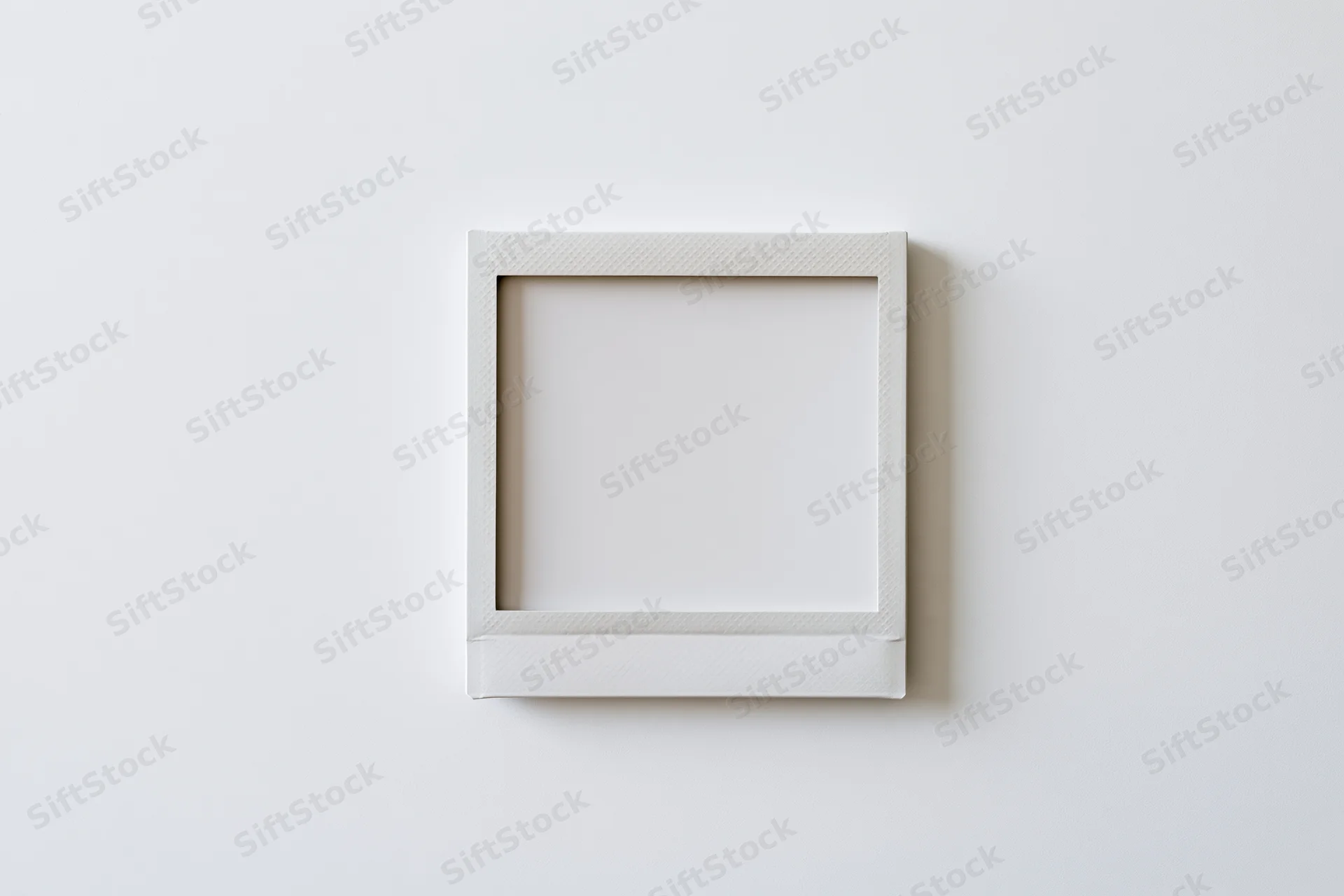 Blank instant photo print lying flat on white surface