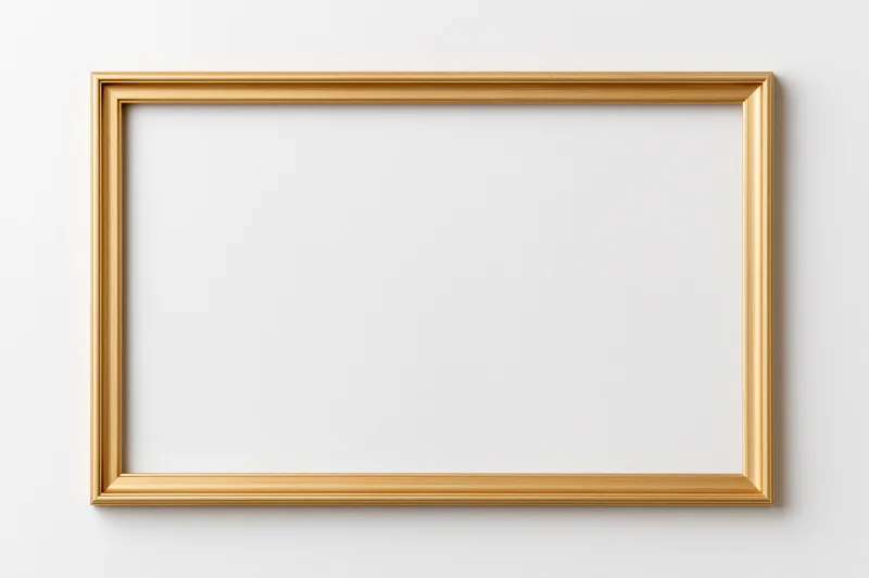 Gold rectangular picture frame lying flat on white surface with blank interior