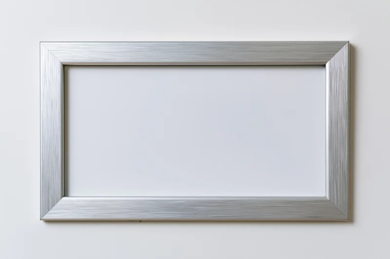 Silver brushed metallic picture frame hanging on white wall with empty white mat inside