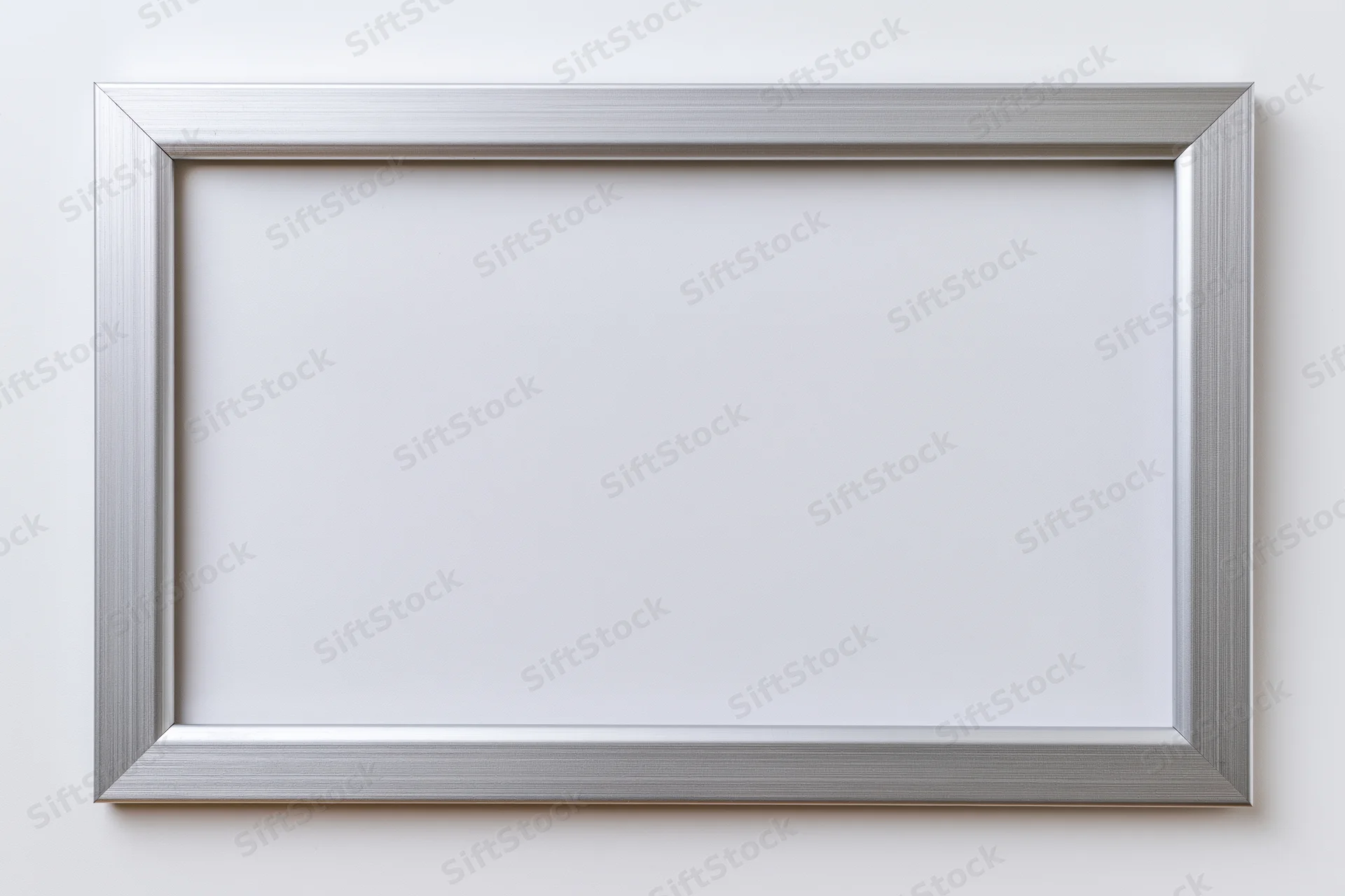 Silver brushed metallic picture frame with white mat on white wall