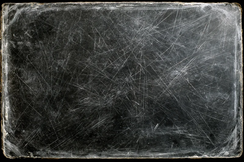 Heavily scratched and worn darkroom photographic paper with visible texture and age marks