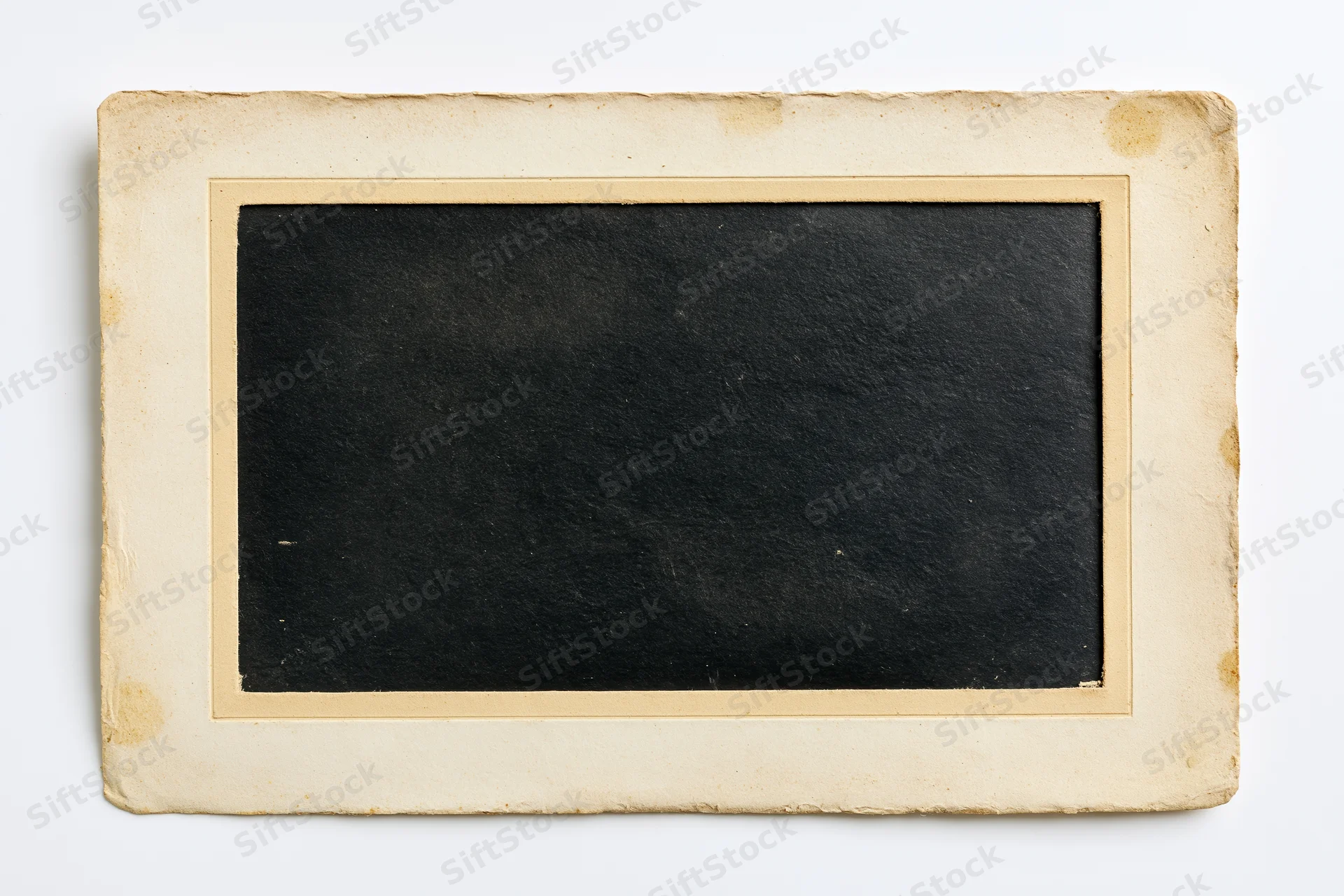 Old blank photographic print with aged paper border lying flat on white background