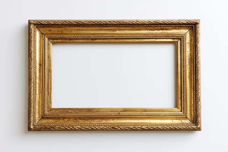 Ornate antique gold picture frame lying flat with empty interior on white background