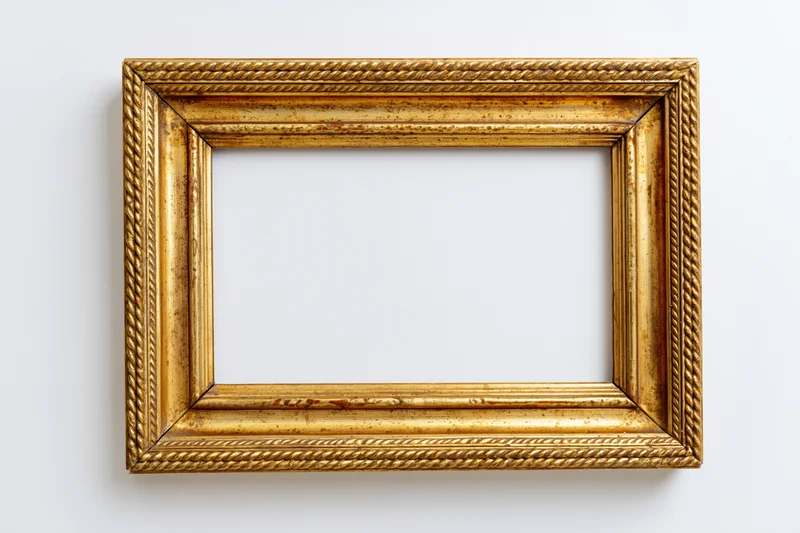 Ornate antique gold picture frame lying flat with empty interior on white background