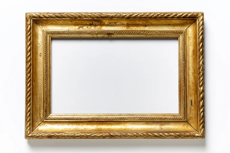 Ornate antique gold picture frame lying flat empty interior