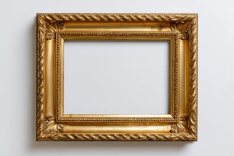 Ornate gold picture frame with carved rope and leaf details hanging on white wall