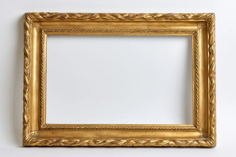 Ornate antique gold picture frame with carved rope and leaf detailing on white background