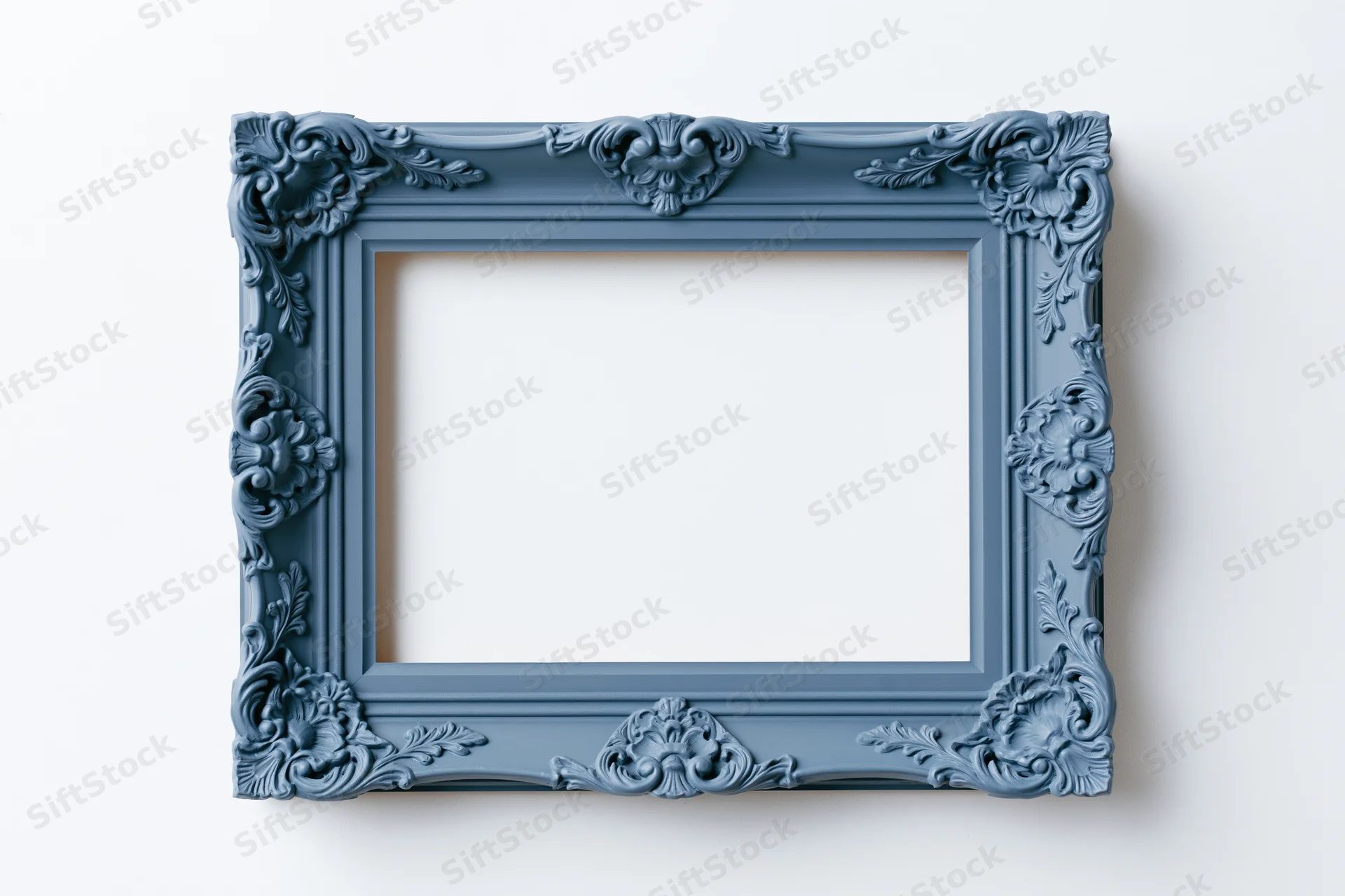 Ornate blue antique frame with carved floral details hanging on a white wall