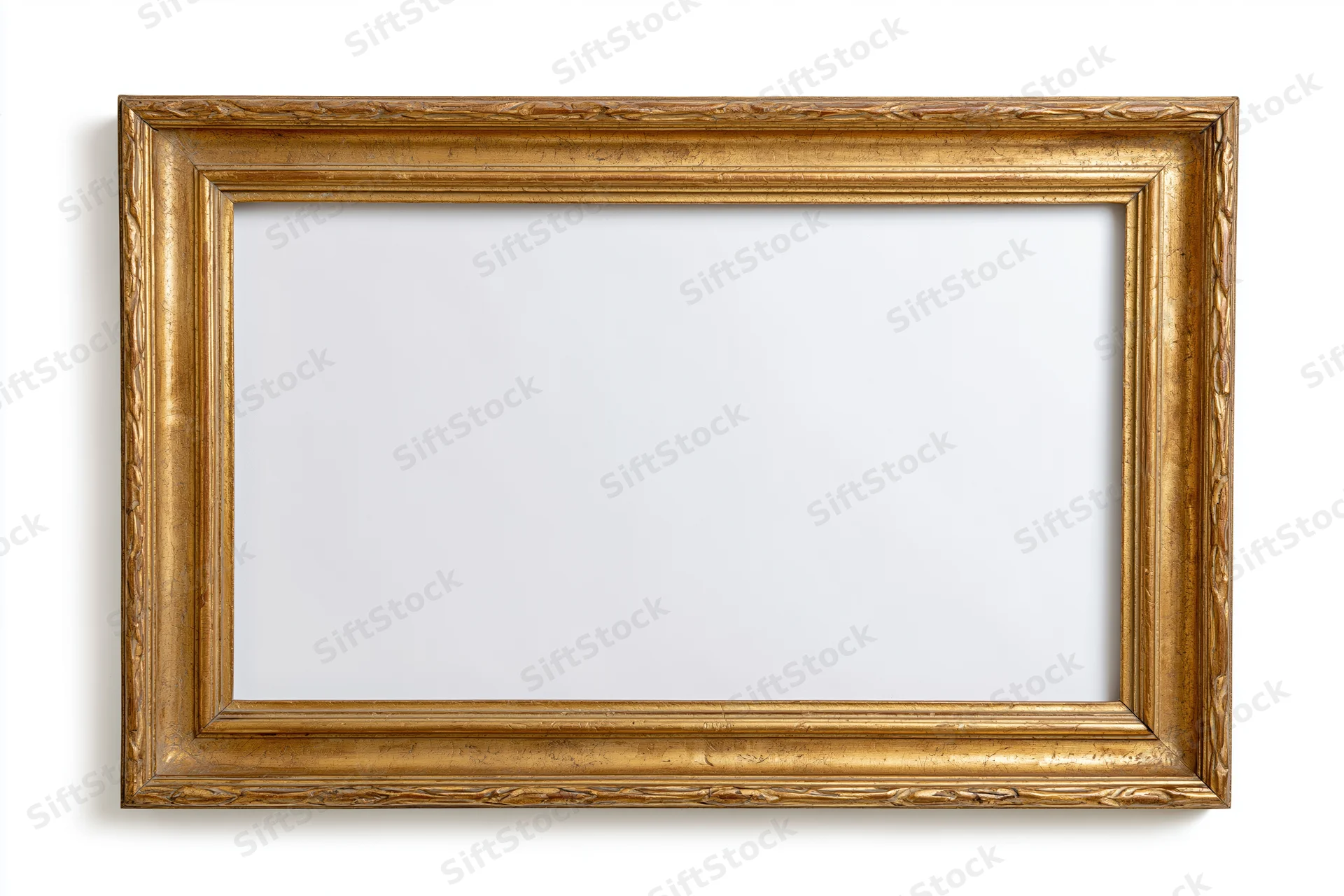 Ornate gold picture frame with carved details on white background