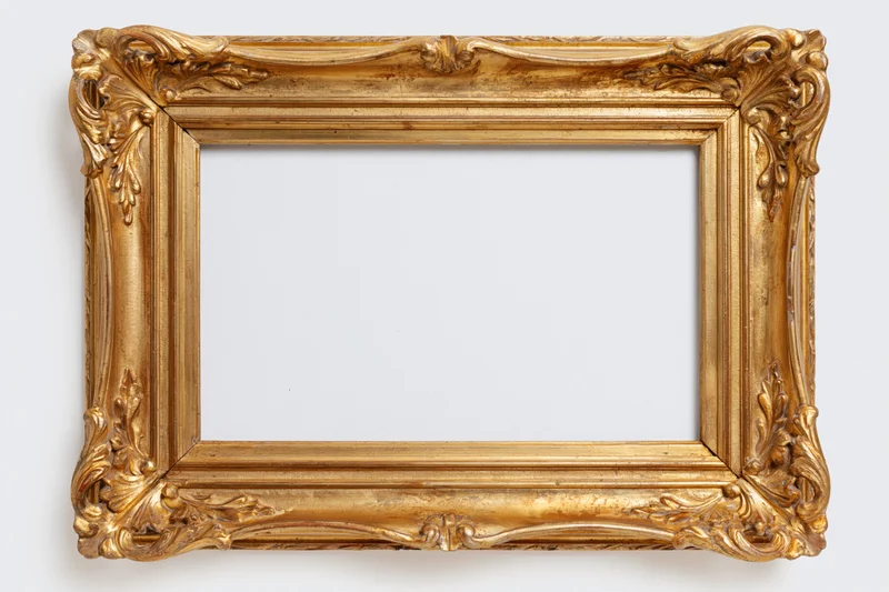 Ornate gilded wooden picture frame with carved floral details on white background