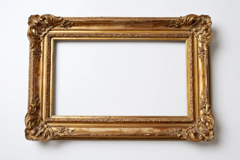 Ornate antique gilded wooden frame with carved floral details on white background
