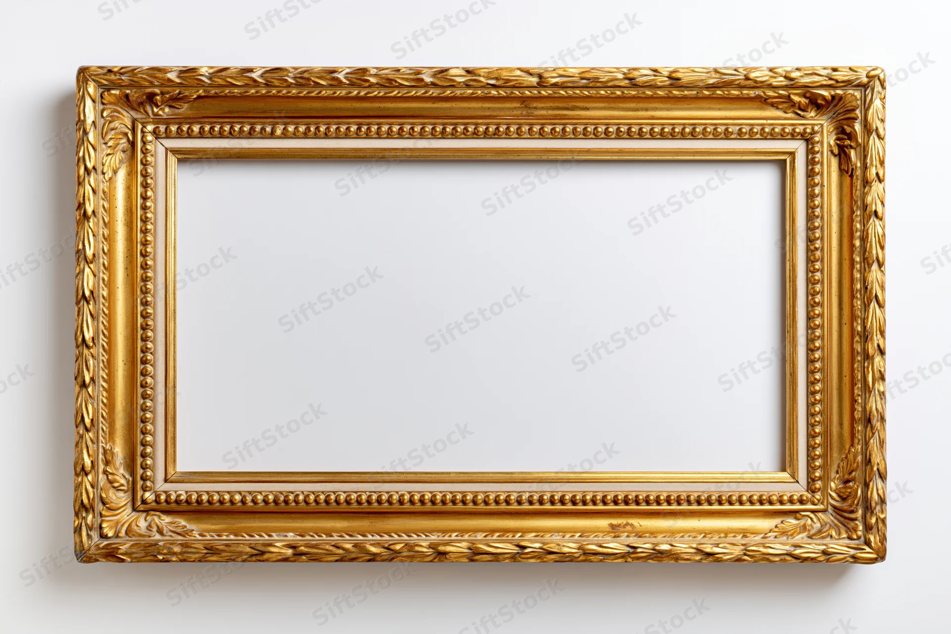 Ornate antique gold picture frame lying flat on white background with empty interior