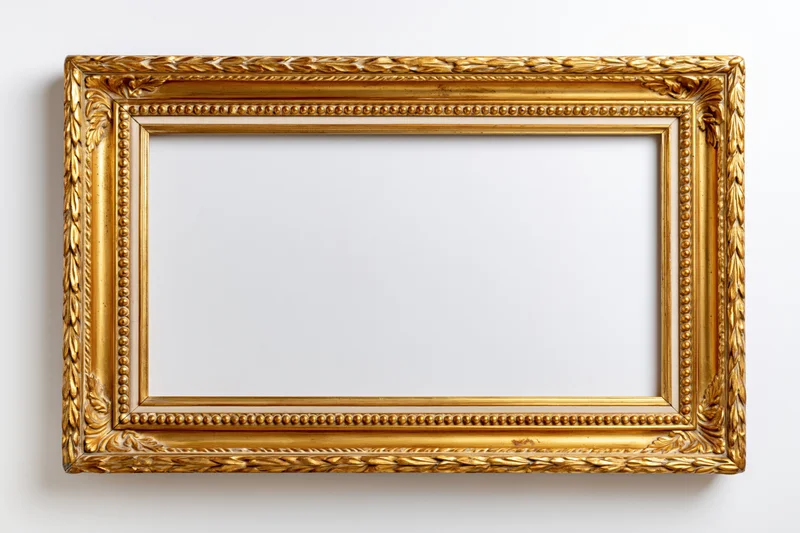 Ornate antique gold picture frame lying flat on white background with empty interior