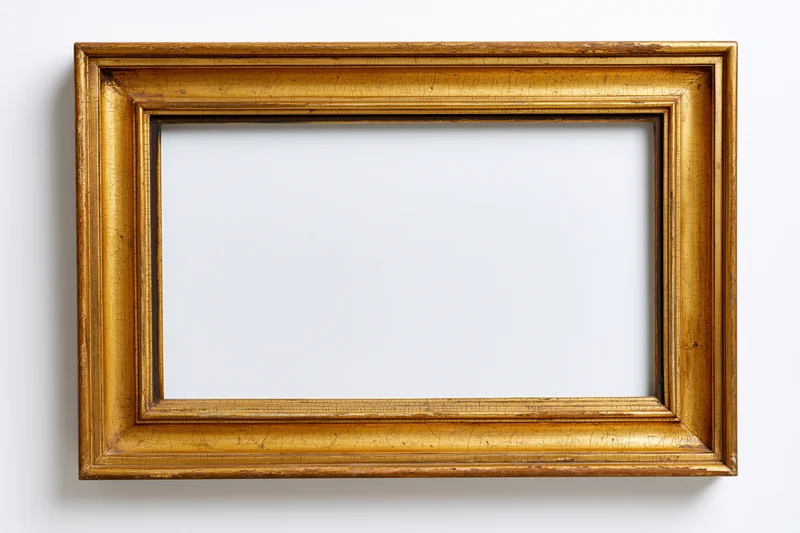 Antique gold picture frame with empty white interior hanging on a wall