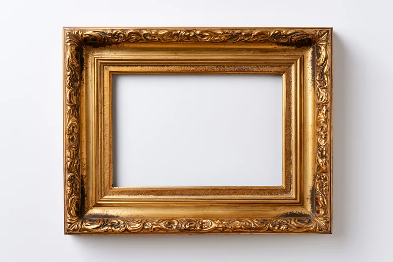 Ornate antique gold picture frame with embossed border detail hanging on white wall
