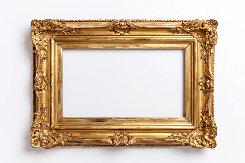 Ornate antique gold picture frame with intricate carvings photographed flat against white background