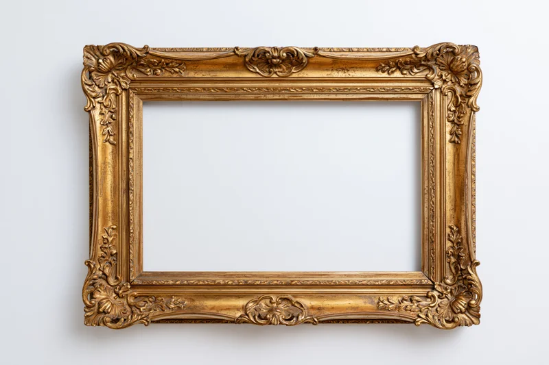 Ornate antique gold picture frame hanging on white wall with empty center for display