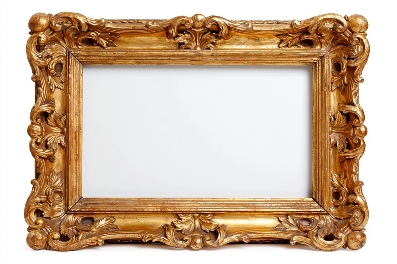 Ornate gold antique frame with intricate carvings and empty white interior isolated on white