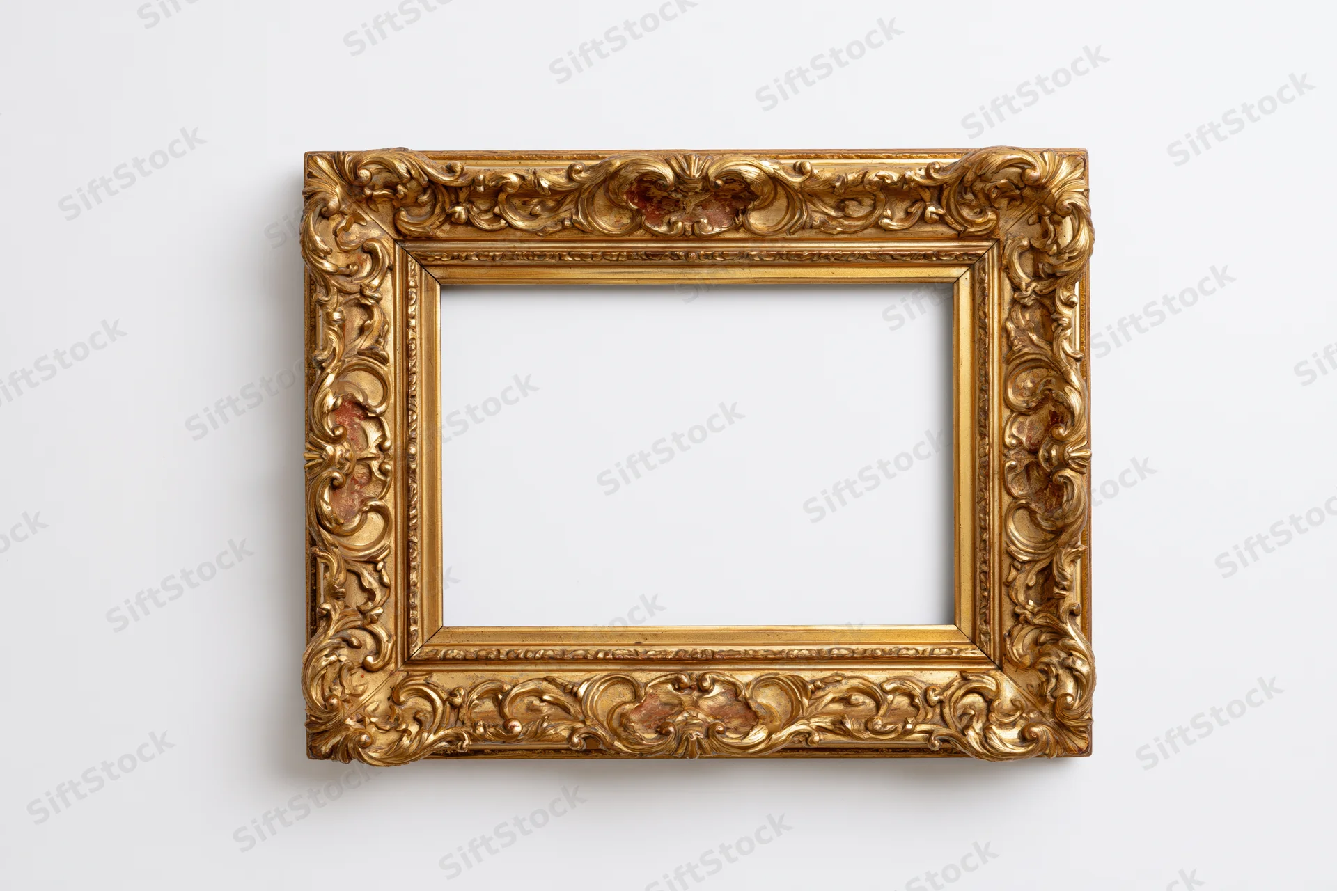 Ornate gold antique frame with carved floral details on white background
