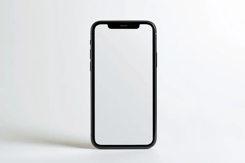 Black smartphone with blank white screen standing upright on white surface
