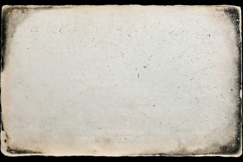 Aged photographic paper with distressed edges and speckled surface lying flat