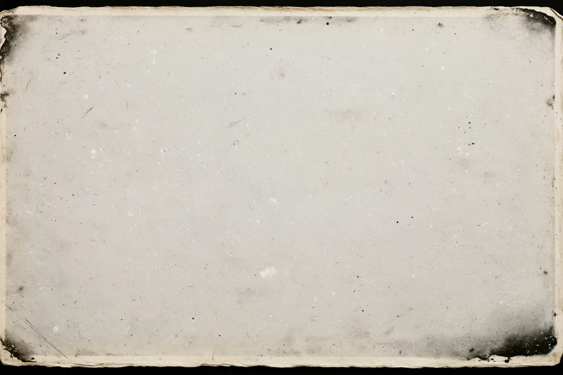 Aged photographic paper with darkened corners and surface imperfections lying flat