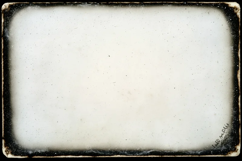 Aged photographic paper with darkroom border burn and textured white surface