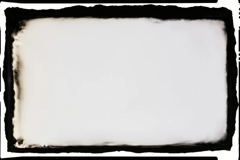 Blank analog film frame with burnt edges and white center area