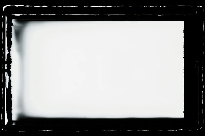 Blank analog film frame in large format negative holder with dark borders and white center