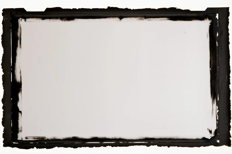 Blank film negative frame with black burnt edges on white background