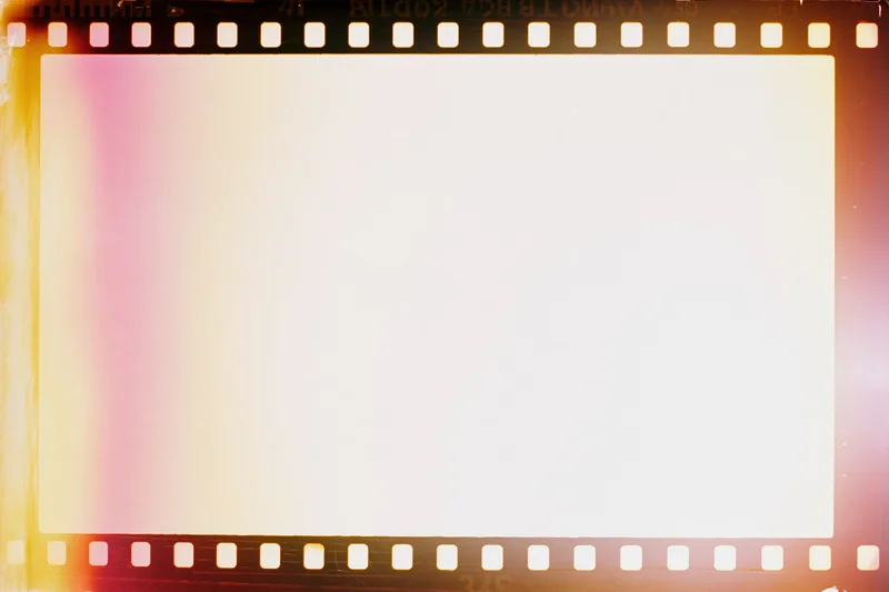 Blank overexposed 35mm film frame with light leak bleed and warm color wash