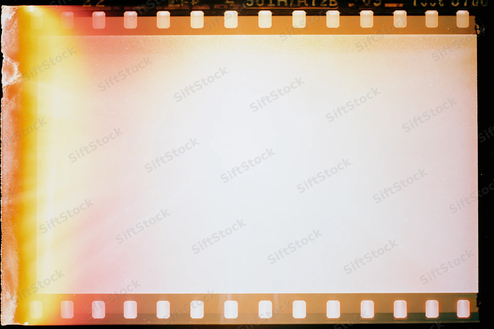 Blank overexposed 35mm film frame with light leak bleed and sprocket holes