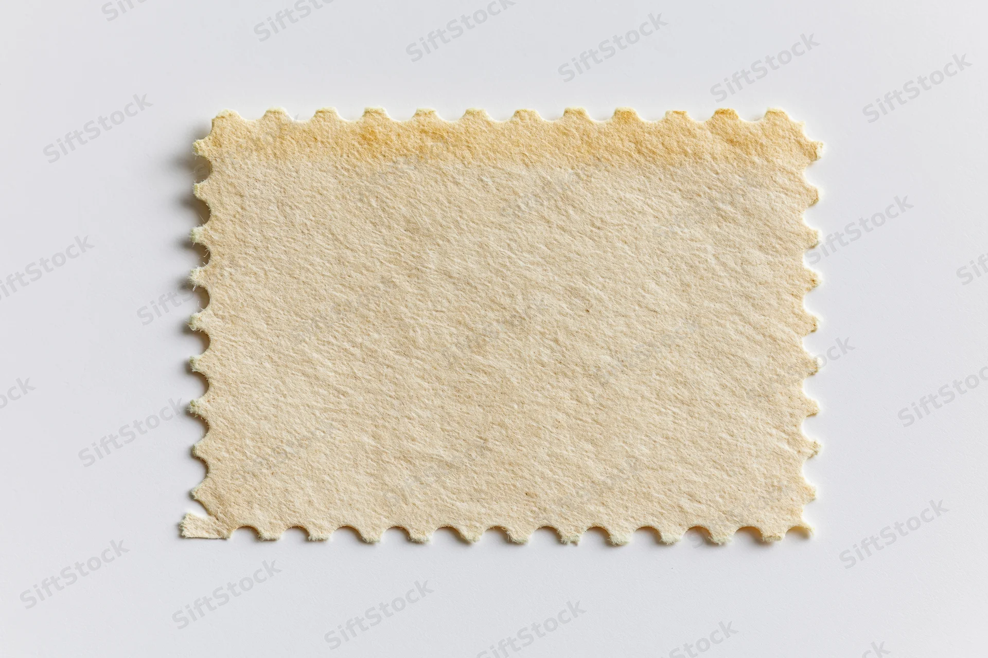 Blank postage stamp with perforated edges on white background