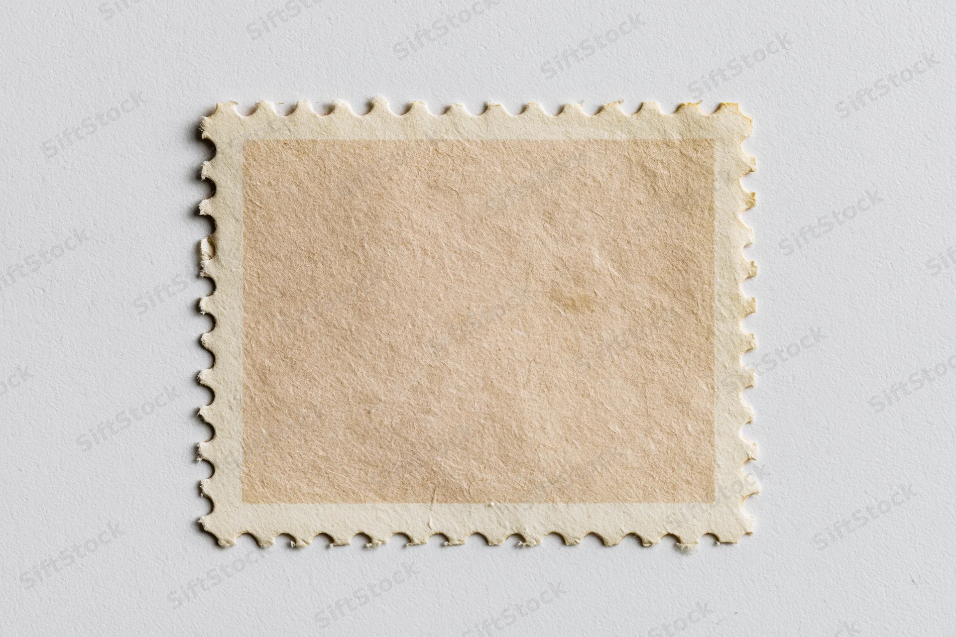 Blank postage stamp with perforated edges on white background