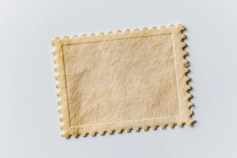 Blank postage stamp with perforated edges on white background